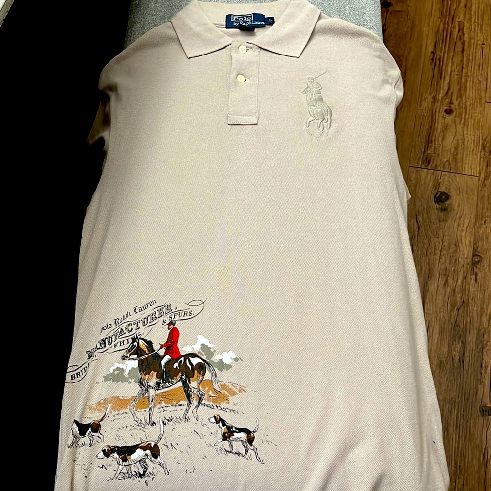 Brown/Tan Polo shirt worn one time, designs located in front, sleeves and back.